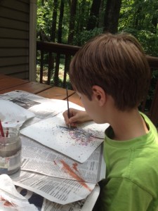 Painting the tree trunk onto the splattered page.